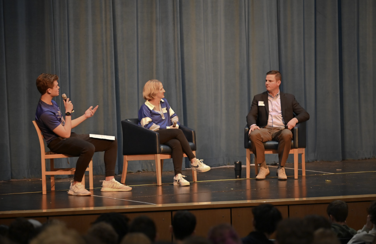 Brennan Bucher (12) asks questions to the guest speakers Julie Kuhnhein and Ben Pendrey about their role in the Fort Thomas community and what got them there. 